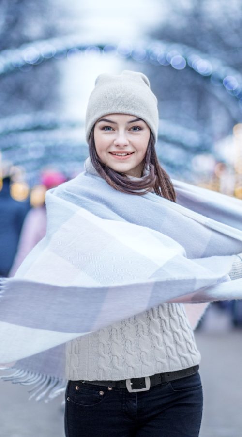 Happy young woman wearing a hat and a scarf. Concept Lifestyle, Urban, Winter, Vacation